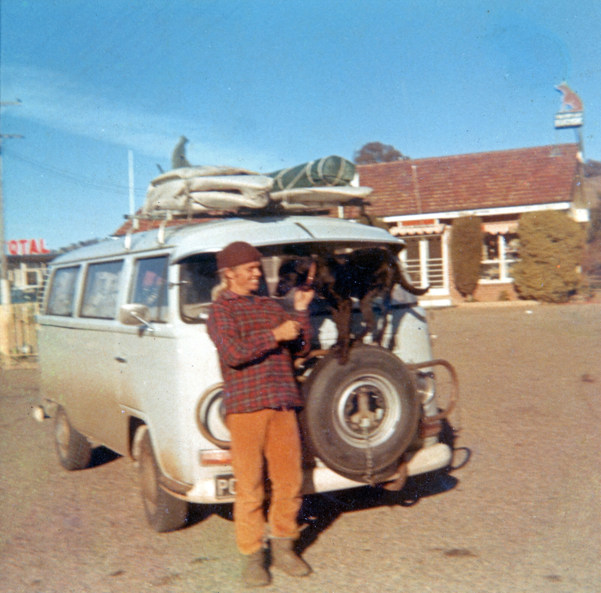 Combi with surfboards strapped to roof, 1972
