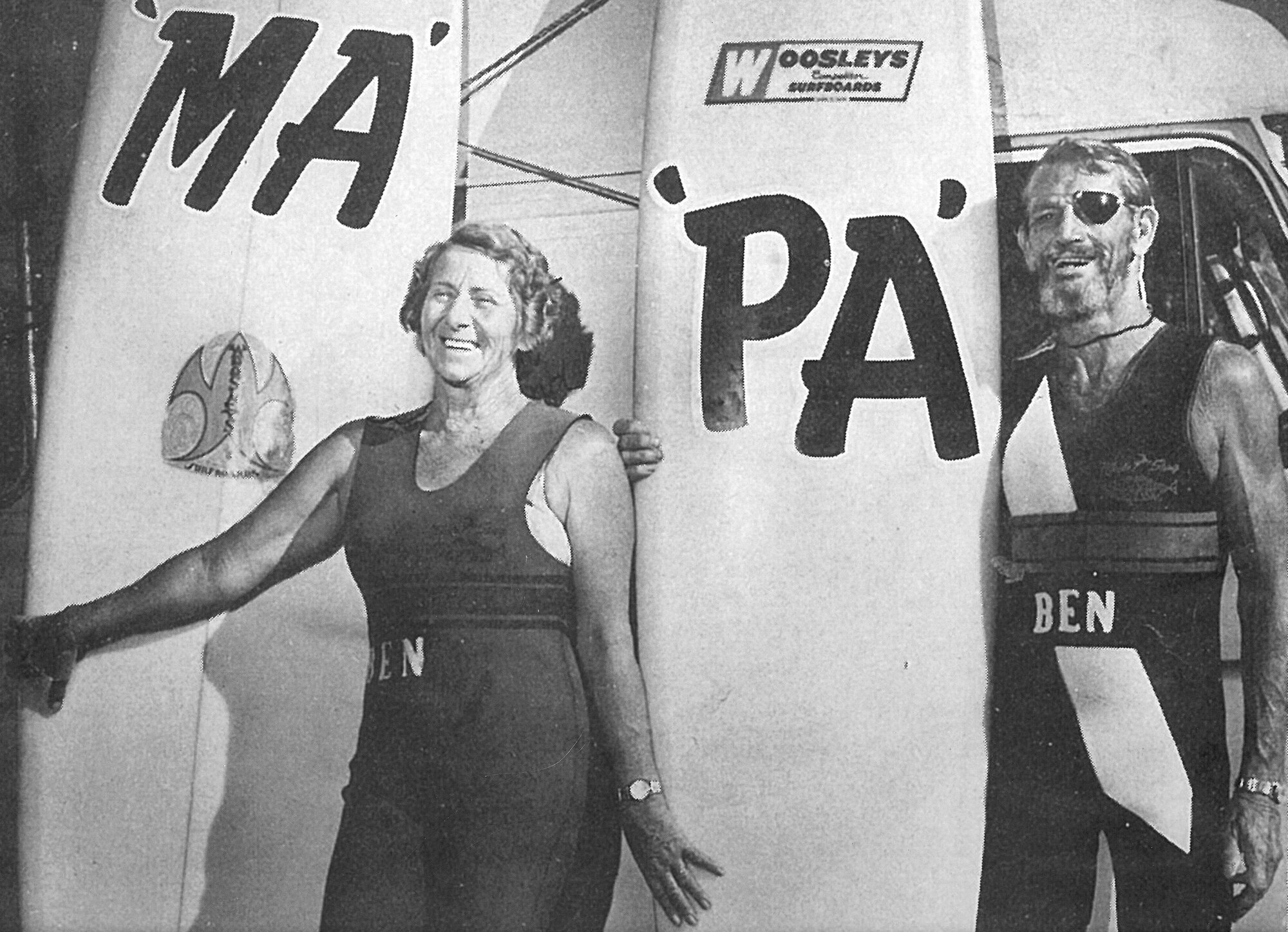 Ma and Pa Bendall of Caloundra standing beside their Woosleys surfboards, ca. 1965