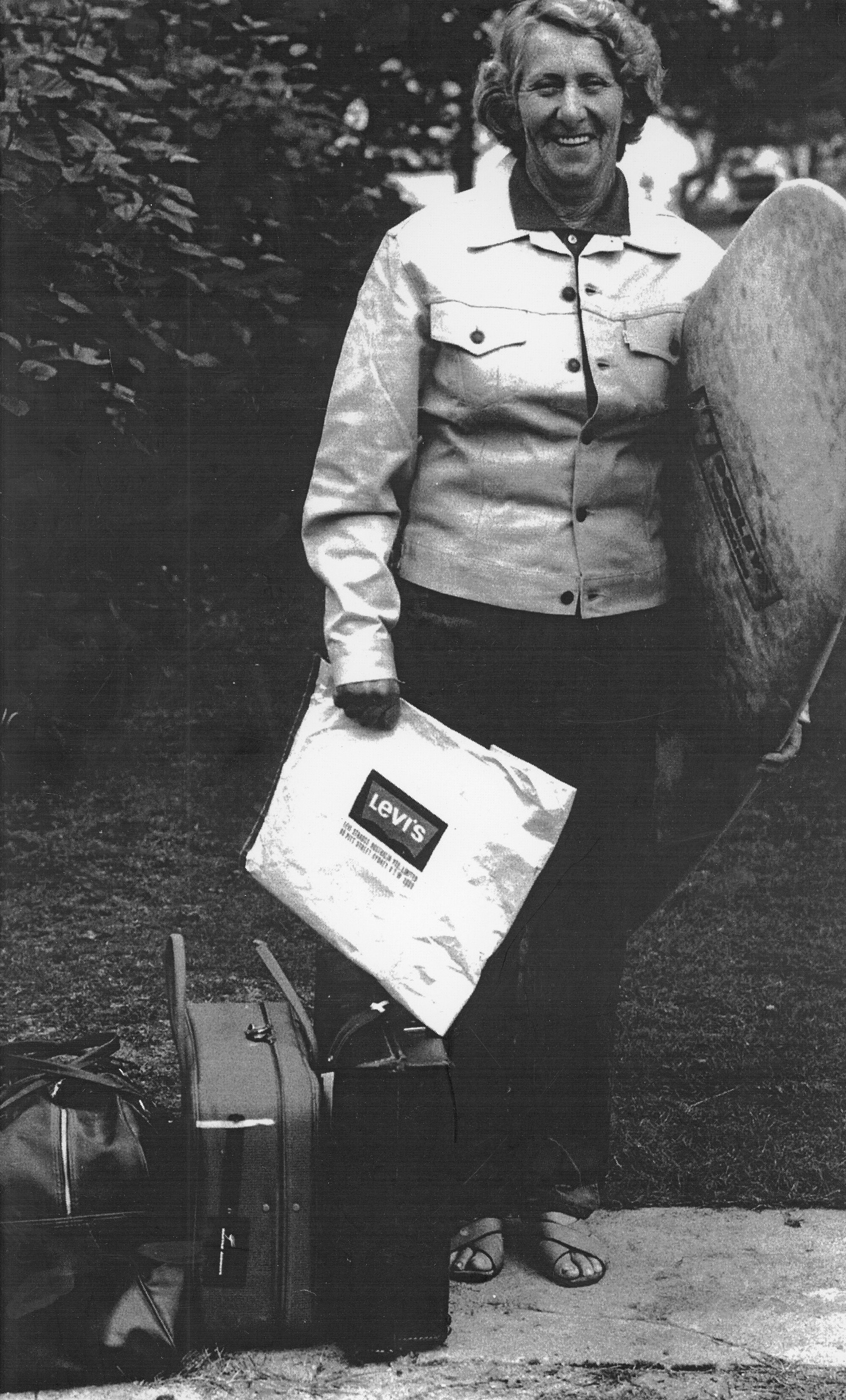 Ma Bendall with suitcases and surfboard, date unknown