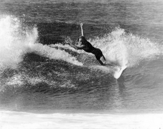 Surfer Andy Geddes surfing at Kings Beach, Caloundra, ca 1970