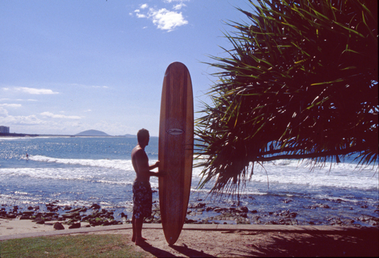 Surfer with his Cutloose longboard, Alexandra Headland, 1980s