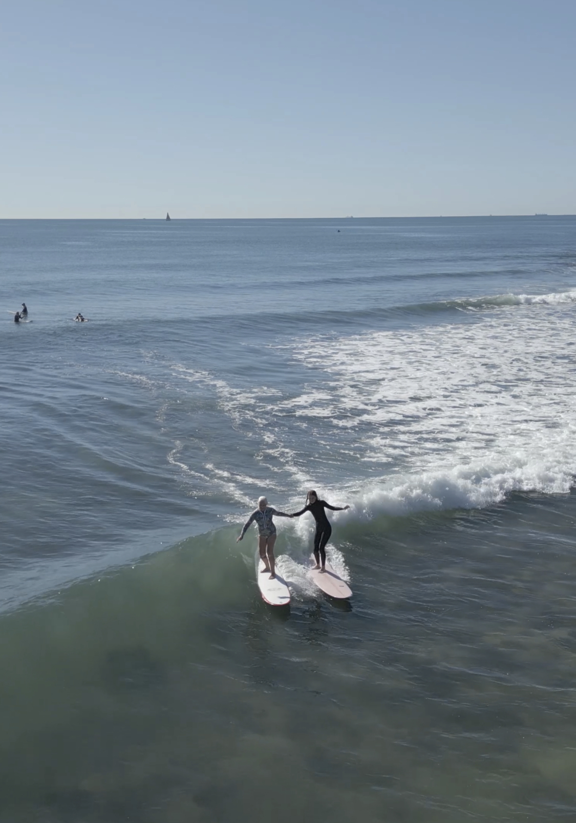 Noela and granddaughter surfing at Alexandra Headland