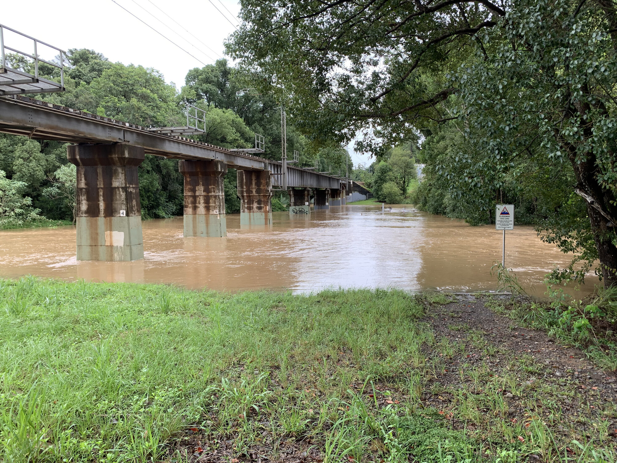 Flood waters under the railway bridge. Woombye. February 2022.