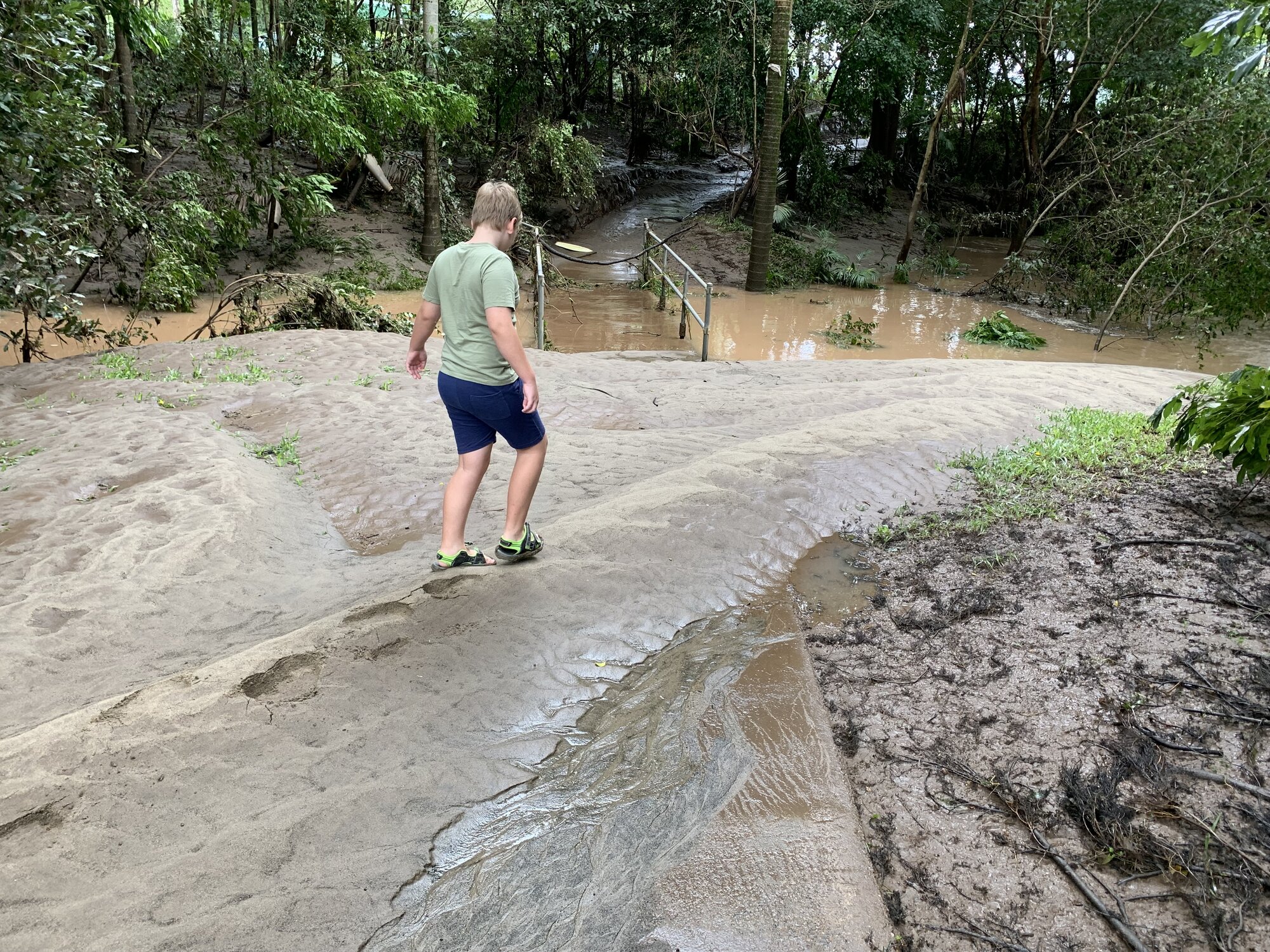 Flood mud on the footpath at Model Railway Park, Nambour. February 2022