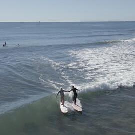 Noela and granddaughter surfing at Alexandra Headland