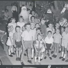 #35 - 1967 SEAQ Christmas Party 1967 - Santa with group of children