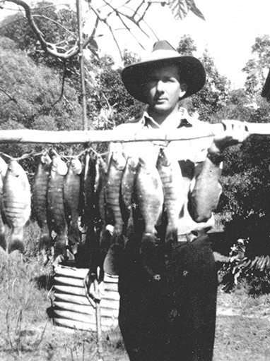 John Mayes displays a good catch of blackfish at his home in Bowman Road, Caloundra, ca 1935.